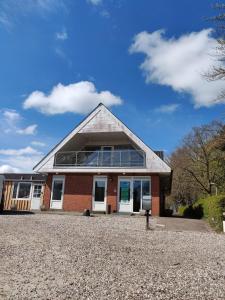 a red brick building with a pyramid roof at Løgstør Camping in Løgstør