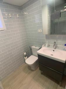 uma casa de banho com um WC branco e um lavatório. em Motril - Poniente Beach em Motril