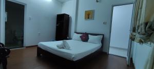 a bedroom with a white bed in a room at Mango Garden Hoi An Homestay in Hoi An