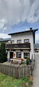 a white house with a fence in front of it at Maridl`s Ferienhaus in Umhausen