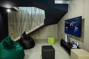 a living room with a flat screen tv and a couch at Villa LorKia in Baška