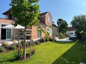 a garden in front of a house with an umbrella at Oggau Cottage in Oggau