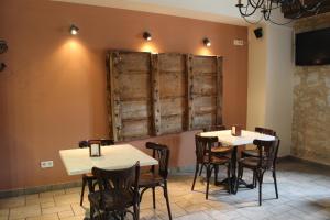 two tables and chairs in a room with wooden walls at Hotel Rural Restaurante Las Baronas in Santa Cruz de la Salceda +26 photos