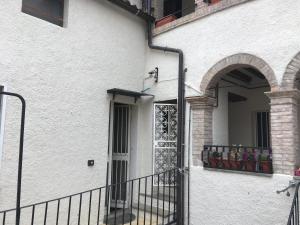 a white building with a gate and a balcony at I 3 FRATELLI in Foligno