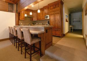 a kitchen with a large island with bar stools at Flagstaff Three Bedroom Suite with Majestic Mountain Views condo in Park City
