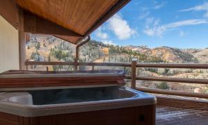 a hot tub on a balcony with a mountain view at Flagstaff Three Bedroom Suite with Majestic Mountain Views condo in Park City
