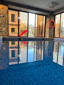 a swimming pool with a view of a building at nbz chalet Jasmine stairs in Al ‘Aqar