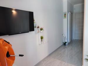 a flat screen tv hanging on a white wall at Midway House AMALFI COAST - POMPEI - SORRENTO COAST- NAPOLI in Sant'Egidio del Monte Albino