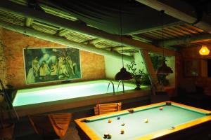 a pool table in a room with a tub at Chambres d'Hôtes Le relais des marmottes in Lagnes