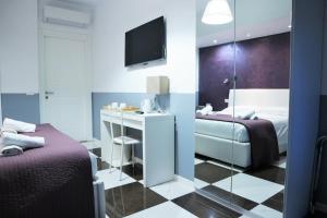 Un ou plusieurs lits dans un hébergement de l'établissement Luxury Vatican Rooms