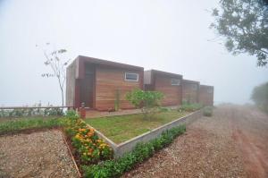 a house with a garden in front of it at Vaya House in Chiang Mai