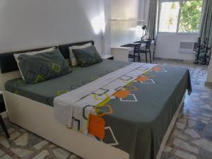 a bedroom with two beds with green and orange sheets at The Three P Beach Resort & Dive Center in Romblon
