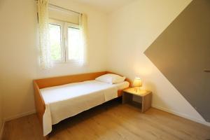Ένα ή περισσότερα κρεβάτια σε δωμάτιο στο Apartman Luce