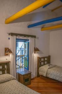 Postel nebo postele na pokoji v ubytování Hotel Museo la Posada del Molino