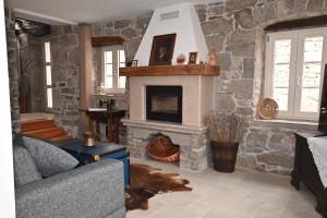 a living room with a stone fireplace at Holiday Home Villa Mavrici in Buzet