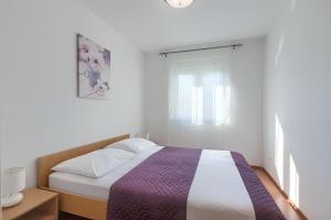Ein Bett oder Betten in einem Zimmer der Unterkunft Apartments Gilly 1
