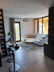 a living room with a couch and a table at Lucia Exclusive with parking in the garage in Poreč