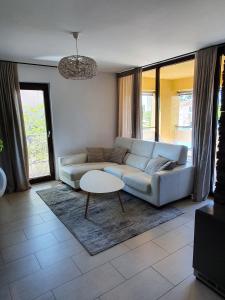 a living room with a couch and a table at Lucia Exclusive with parking in the garage in Poreč