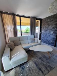 a living room with a couch and a table at Lucia Exclusive with parking in the garage in Poreč