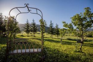 metalowe łóżko na polu trawy z drzewami w obiekcie Mountain House Kosjenka w mieście Kupres