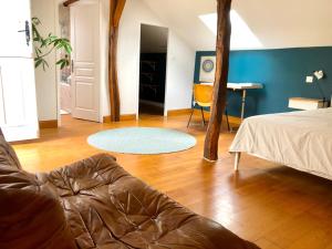a living room with a couch and a table at L'adret du bois in Sames +79 photos