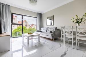 a living room with a couch and a table at MIRA APARTMENTS in Gdańsk