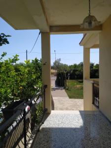 a porch of a house with a gate and a view at Casa Duilia: una villa tra mare e collina in San Vito Chietino