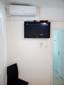 a flat screen tv on the wall of a room at Guest House Jasmin in Rovinj