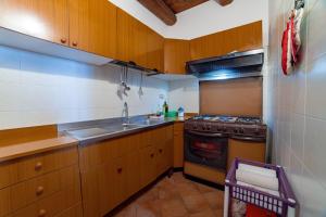 a kitchen with a sink and a stove top oven at Il Prato degli Ulivi in Rocca Imperiale