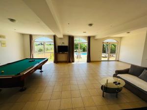 a large living room with a pool table at Orange Tree Garden in Trogir