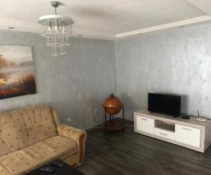 a living room with a couch and a television at sweet home in Nemila