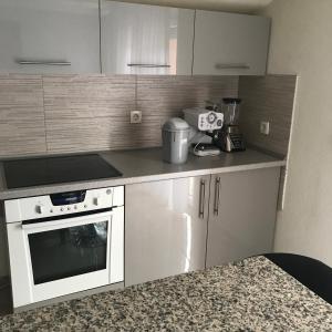 a kitchen with a white stove and a microwave at sweet home in Nemila