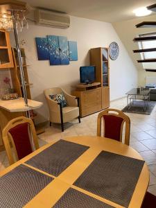 salon ze stołem i krzesłami oraz salon w obiekcie Buborék Apartman w Hajduszoboszlo