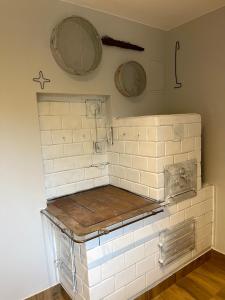 a kitchen with white tiles on the wall at Pod Jabłoniami - Roztocze Susiec Paary in Pary
