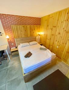 a large bed in a room with a brick wall at Mariami apartment old tbilisi in Tbilisi City