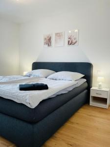 a bed with a blue headboard in a bedroom at Zollernalb-Apartment in Albstadt