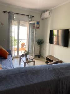 a bedroom with a bed and a view of a patio at dimitris house 2 in Alepou