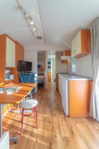 a kitchen with a table and a dining room at Hoamat#am#See in Seekirchen am Wallersee