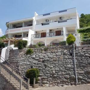 a building on top of a stone wall at Vila Horizont in Sveti Stefan
