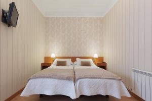 a bedroom with a large bed and two night stands at Hostal Oliva in Barcelona