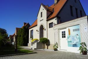 a white church with a mural on the side of it at BRABO in Landskrona