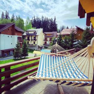 a couple of hammocks sitting on a porch at The Mountain Villa in Poiana Brasov