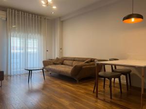 a living room with a couch and a table at Skanderbeg Apartments 3 in Tirana