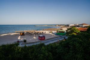 a view of a beach with umbrellas and the ocean at Vila RANYA - Adults Only in Mangalia