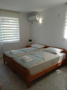 a bedroom with a large bed in a room at Guest House DARIS-APHRODEYA Къща за Гости ДАРИС-АФРОДЕЯ in Sozopol