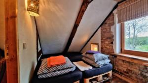 a room with a bench with pillows and a window at Butterfly House in Pāvilosta +140 photos