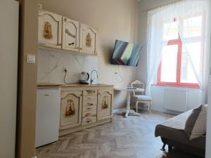a kitchen with a counter and a table in a room at Park Rezydencja in Legnica