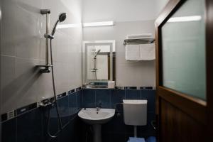 a bathroom with a sink and a toilet and a mirror at Vila RANYA - Adults Only in Mangalia