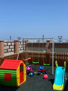 a playground with toys and a swing at Pensiunea DeeaMar in Năvodari