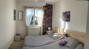 a bedroom with a bed with a stuffed animal on it at Les Villas de Castel - villa "Les Muriers" in Castelmaurou